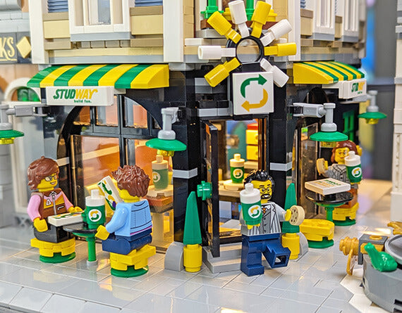 lego moc of a fast food restaurant showing lots of minifigs enjoying food and drink